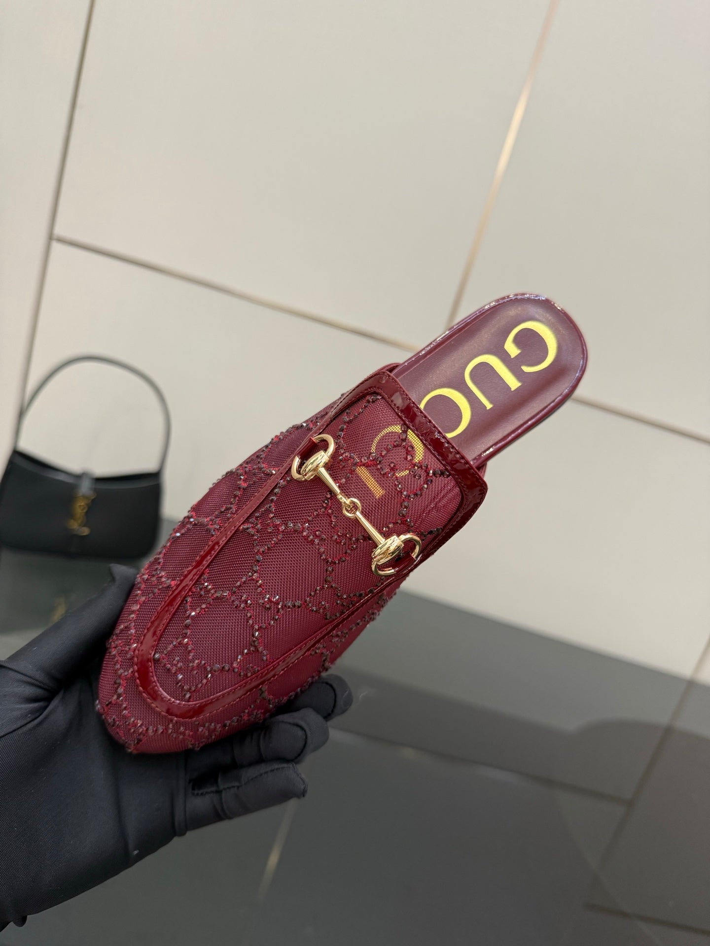 Gucci women's burgundy loafers with gold horsebit, close-up side view