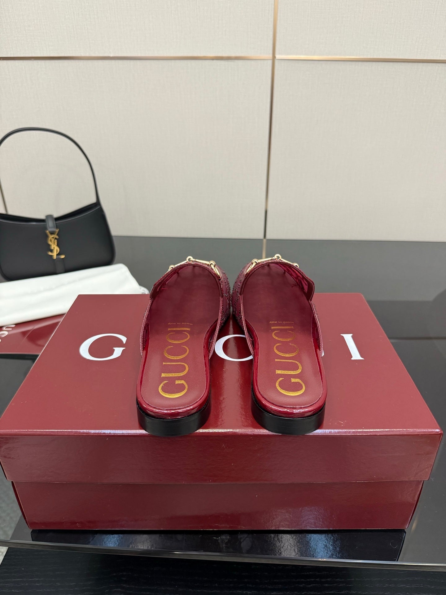 Gucci women's burgundy loafers, heel and insole view with gold trim
