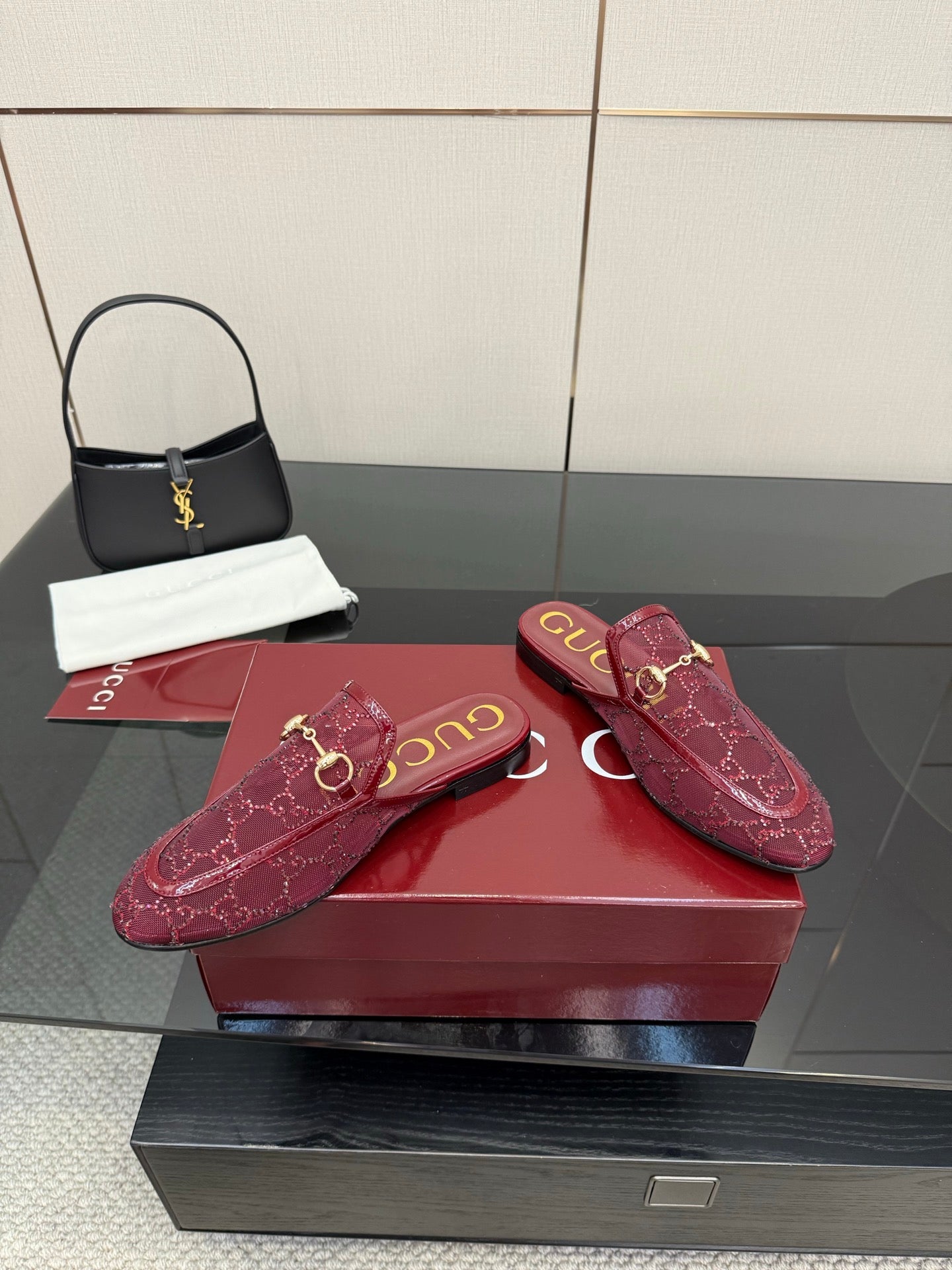 Gucci women's burgundy horsebit loafers, side view with textured monogram