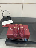 Gucci women's burgundy loafers with gold horsebit detail and monogram pattern