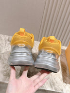 Dior unisex sneakers heel view, yellow uppers with thick gray and silver soles