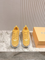 Dior unisex sneakers, yellow upper with gray cushioned soles and lace-up design
