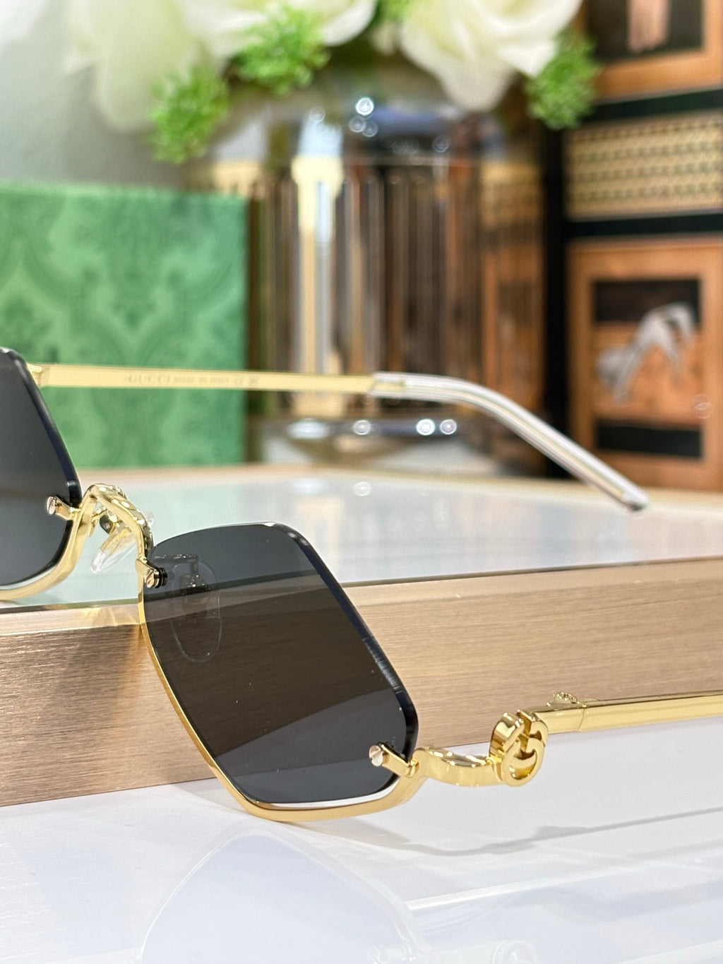 Gucci glasses with gold-tone cat-eye frame and dark lenses
