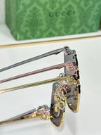 Gucci glasses close-up with gold-tone hinges and rose-and-blue temples