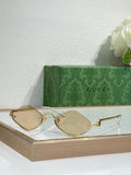 Gucci glasses with gold-tone cat-eye frames and light tan lenses
