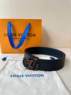 Black monogram leather belt with metal LV buckle, flat lay