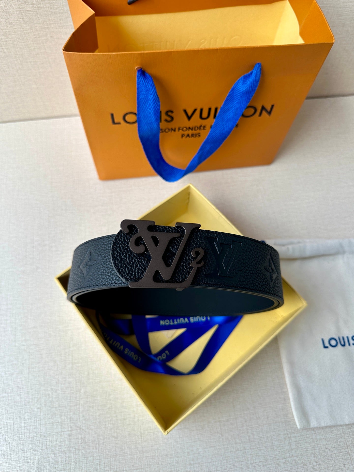 Black leather belt with metal LV buckle and embossed monogram on band