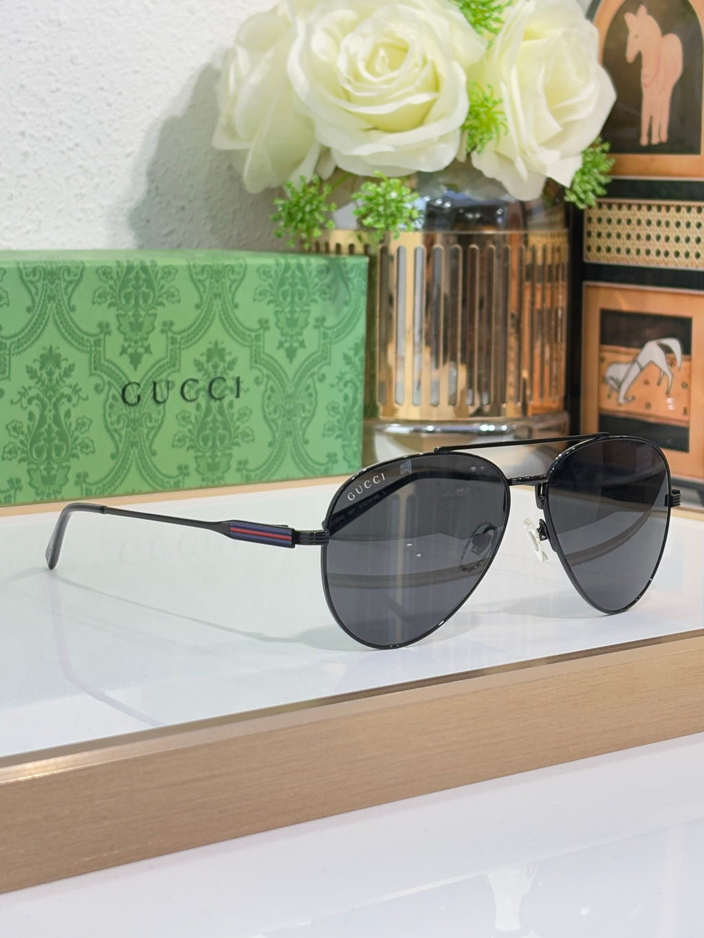 Gucci aviator-style sunglasses with dark lenses and slim metal arms