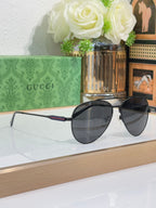 Gucci aviator-style sunglasses with dark lenses and slim metal arms