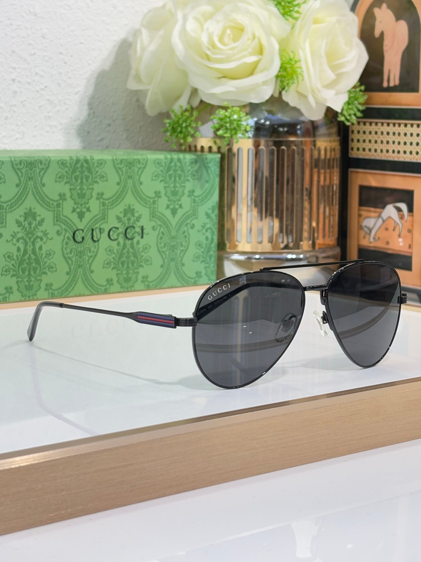 Gucci aviator-style sunglasses with dark lenses and slim metal arms
