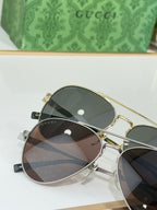 Gucci gold-rim eyeglasses with dark mirrored lenses and slim temples