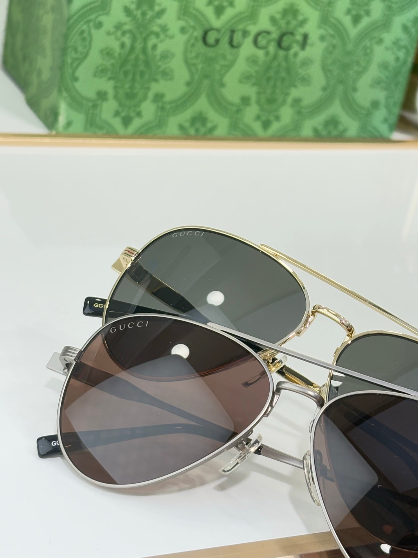 Gucci gold-rim eyeglasses with dark mirrored lenses and slim temples