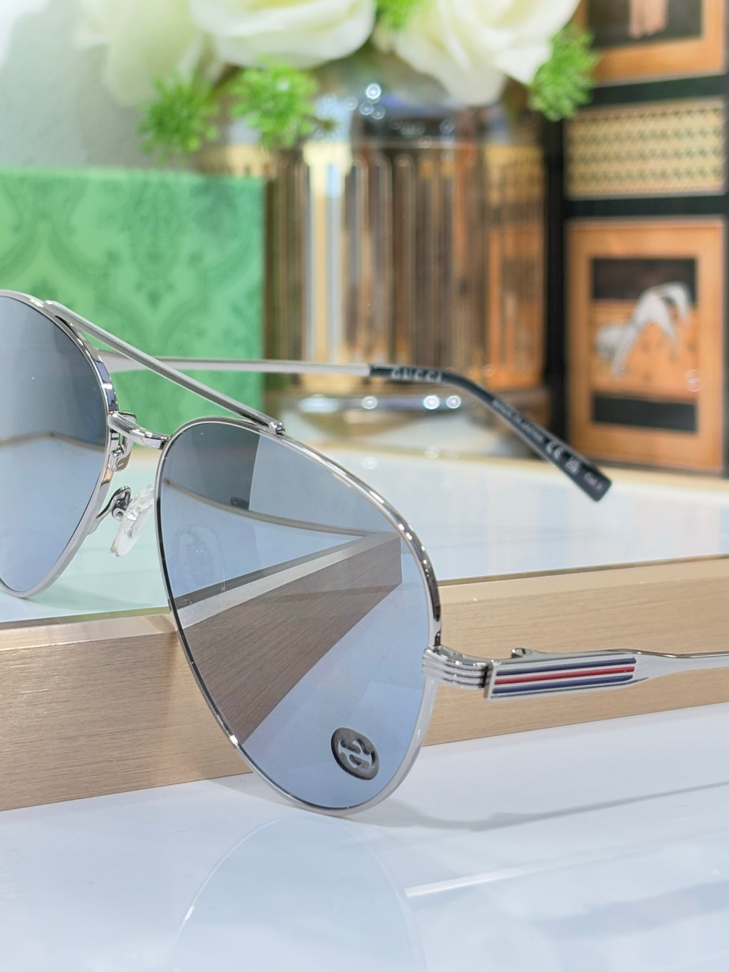 Gucci aviator-style sunglasses with silver frame and dark tinted lenses
