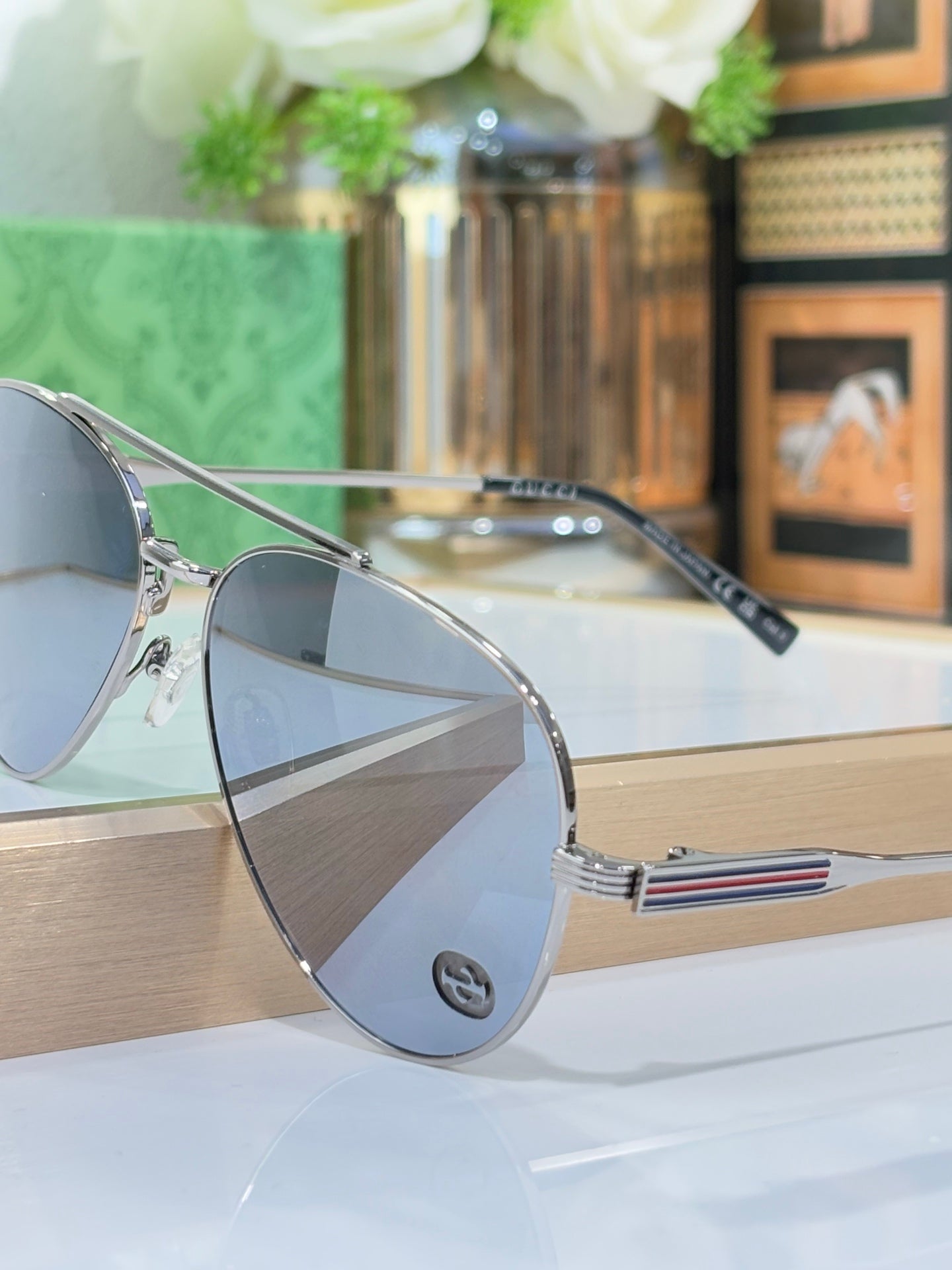 Gucci aviator-style sunglasses with silver frame and dark tinted lenses