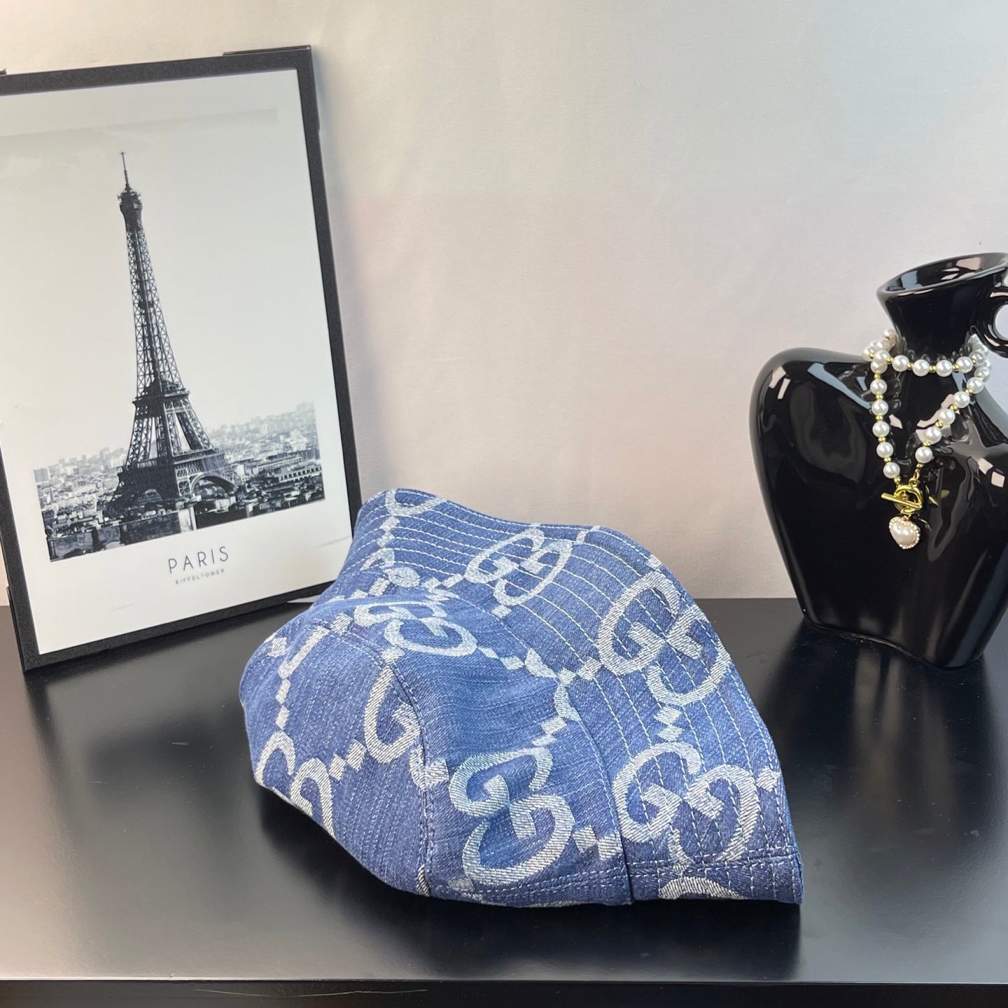 Gucci blue GG-pattern denim bucket cap, profile view with curved brim