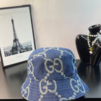 Gucci blue GG-pattern denim bucket cap, front view with allover logos
