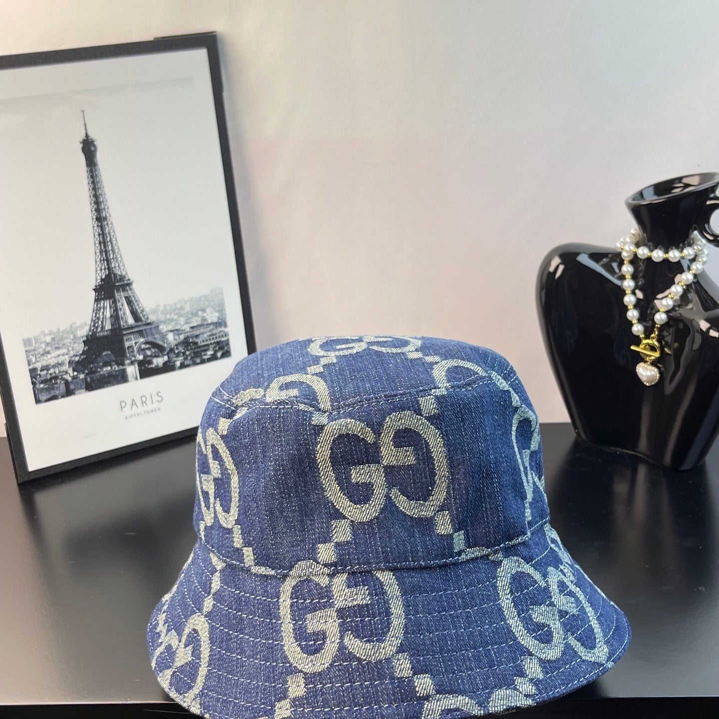 Gucci blue GG-pattern denim bucket cap, front view with allover logos