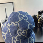 Gucci blue GG-pattern denim bucket cap, angled view of logo print