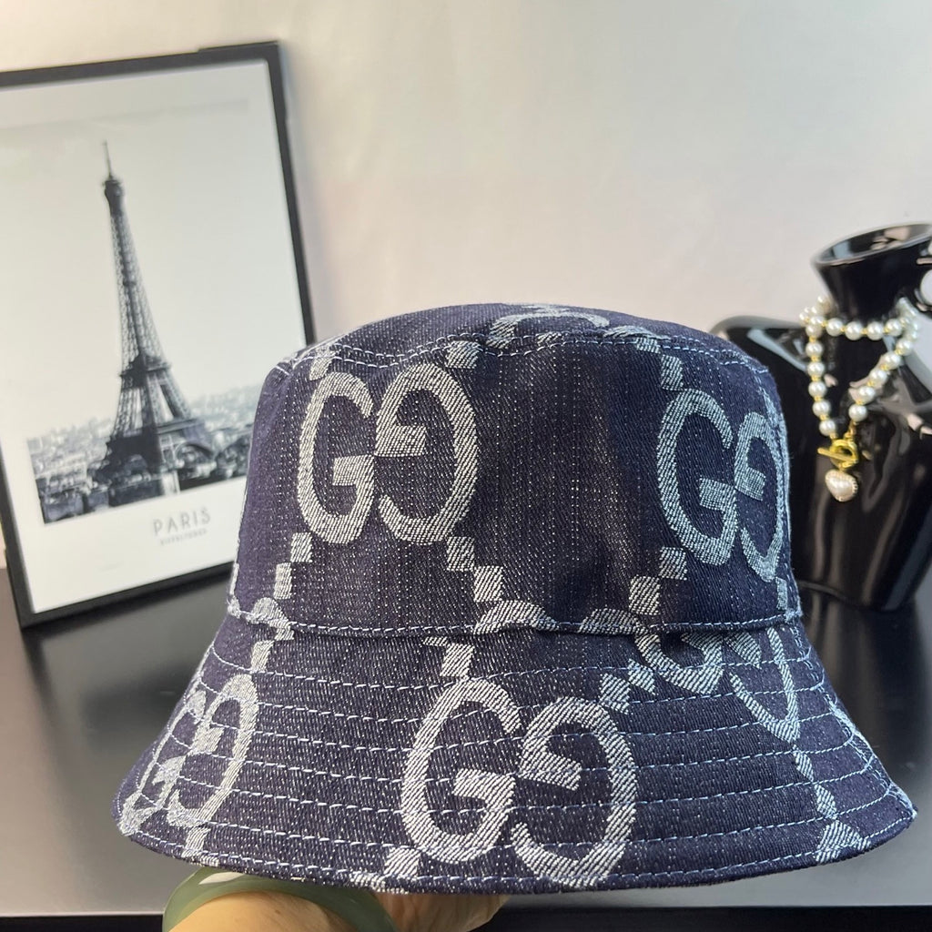 Gucci bucket cap in dark denim with white GG logo embroidery-style pattern