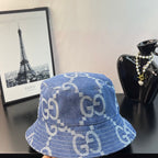 Gucci GG denim bucket hat in blue with repeating GG monogram print, side view