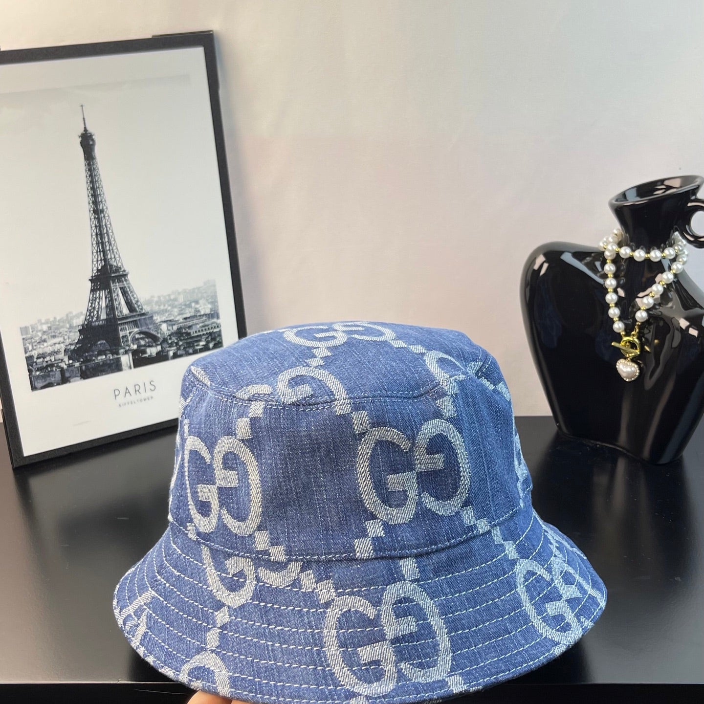 Gucci GG denim bucket hat in blue with repeating GG monogram print, side view