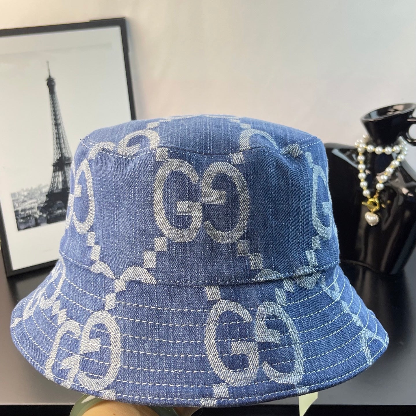 Gucci GG denim bucket hat in blue with repeating monogram print, close side