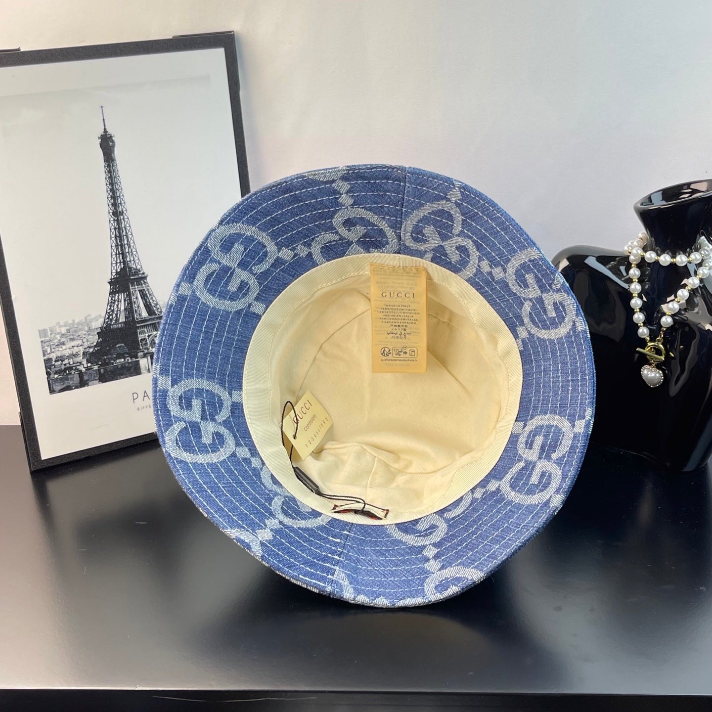 Gucci GG denim bucket hat shown from inside, blue monogram fabric