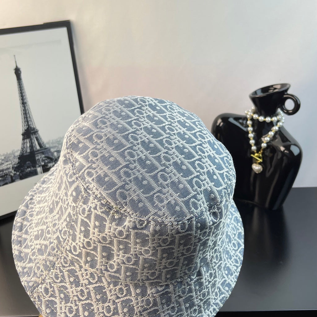 Gucci bucket cap with light blue monogram pattern, angled view