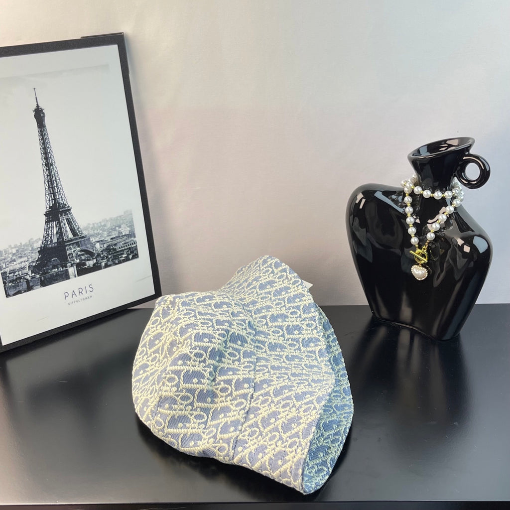 Gucci bucket hat in light blue with gold monogram pattern, front view