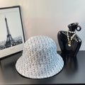 Dior bucket hat in light blue with white monogram-style pattern and curved brim