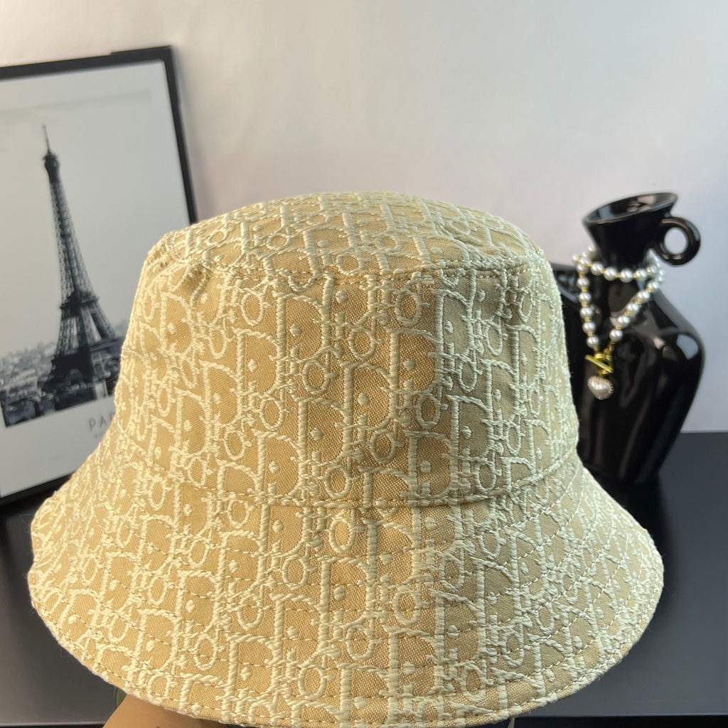 Dior monogram bucket hat in light gold with dense logo pattern and curved brim