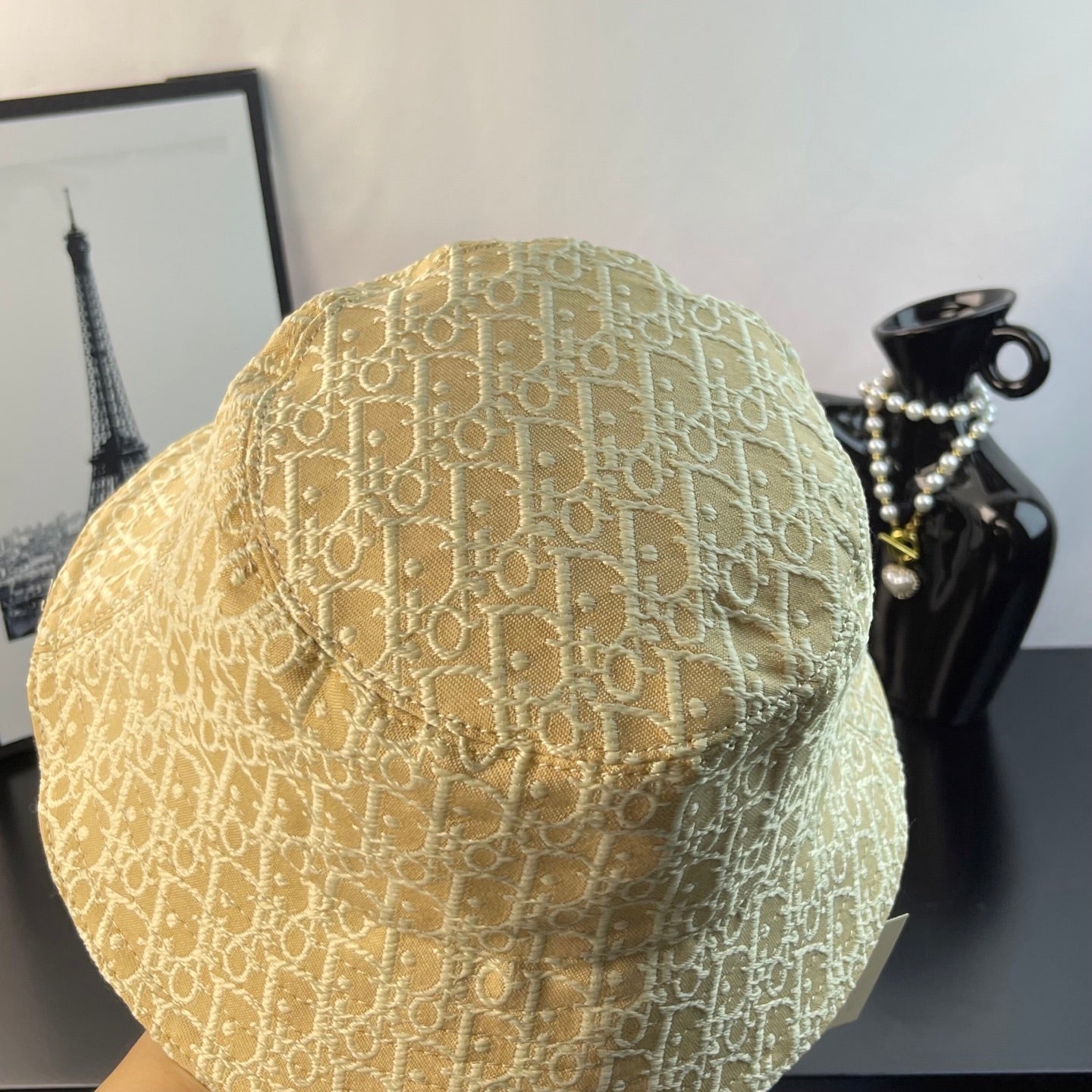 Dior monogram bucket hat in light gold, angled view showing stitched crown