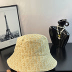 Bucket cap in yellow with textured-looking monogram pattern