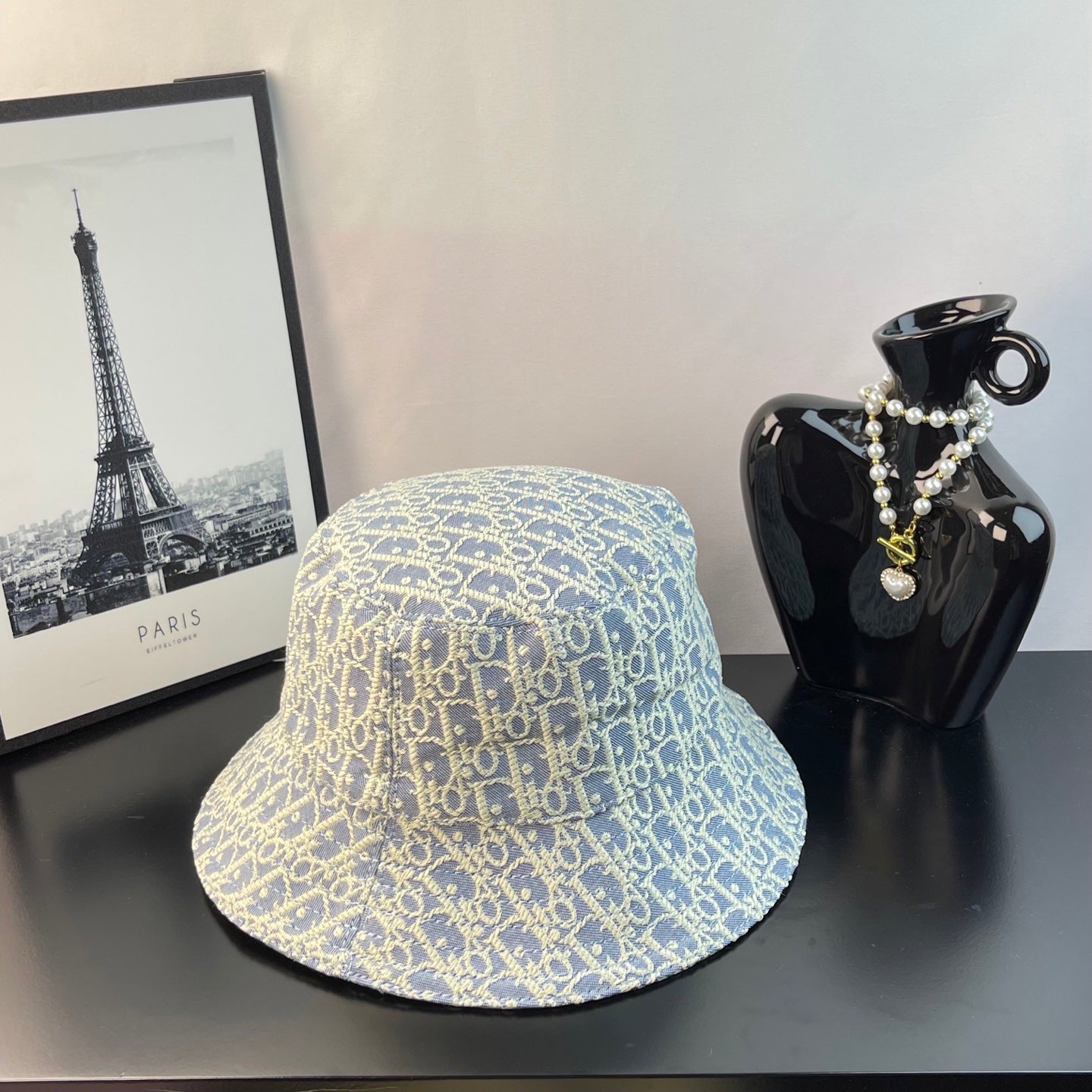 Dior monogram bucket cap, light blue with gold logo pattern, wide brim