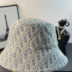Gucci bucket hat back view in light blue with gold monogram pattern