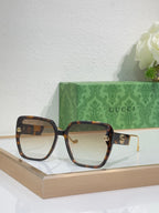 Gucci sunglasses with tortoiseshell frame and amber-tinted lenses