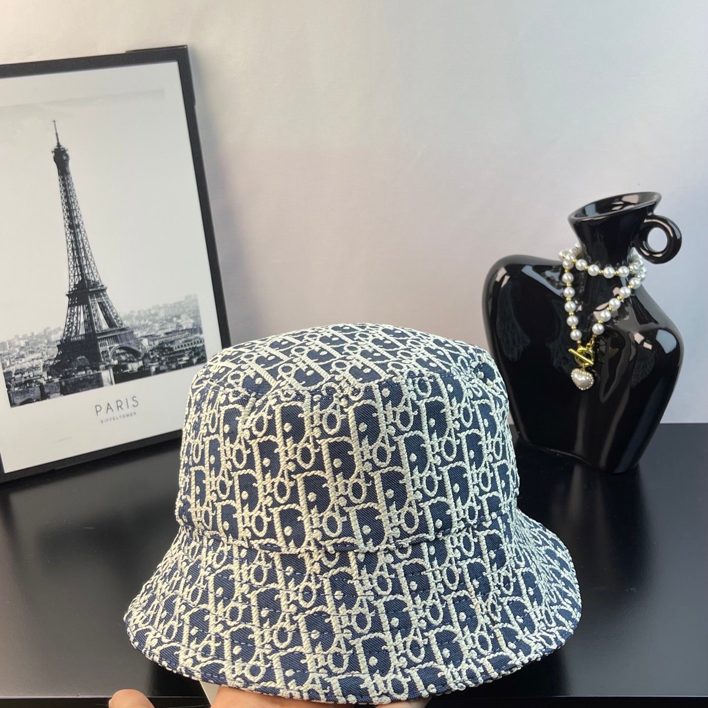 Gucci monogram bucket cap, side view in blue with gold-toned print