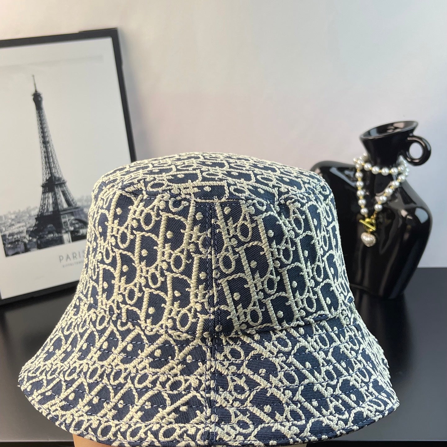 Gucci monogram bucket cap, front view in blue with gold-toned logo print