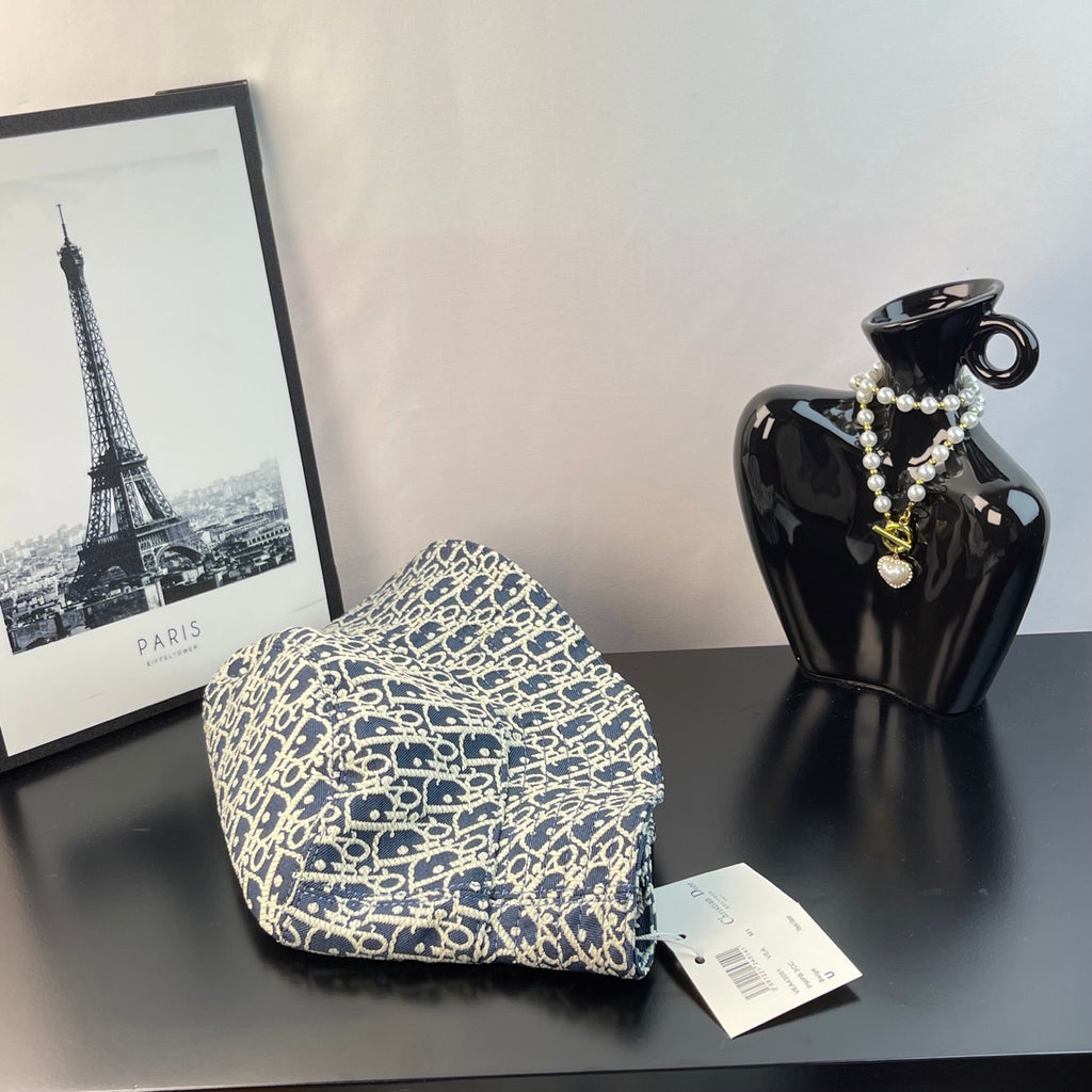 Dior monogram bucket hat in blue with gold pattern, tag attached