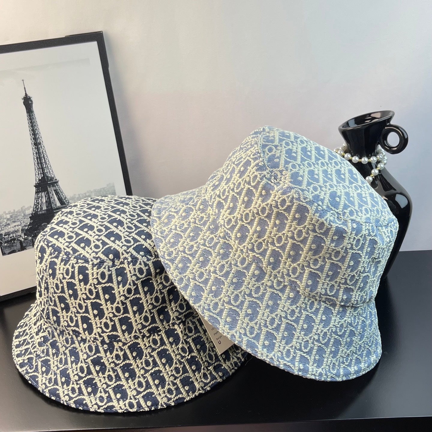 Gucci monogram bucket caps in two shades of blue with gold-toned print