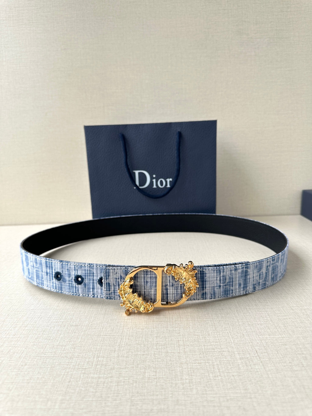 Dior patterned belt with blue fabric weave and gold medallion-style buckle