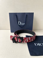 Dior belt with red monogram strap and black buckle on adjustable leather belt.