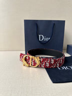 Dior belt with red monogram strap, black backing, and gold-tone ornate buckle