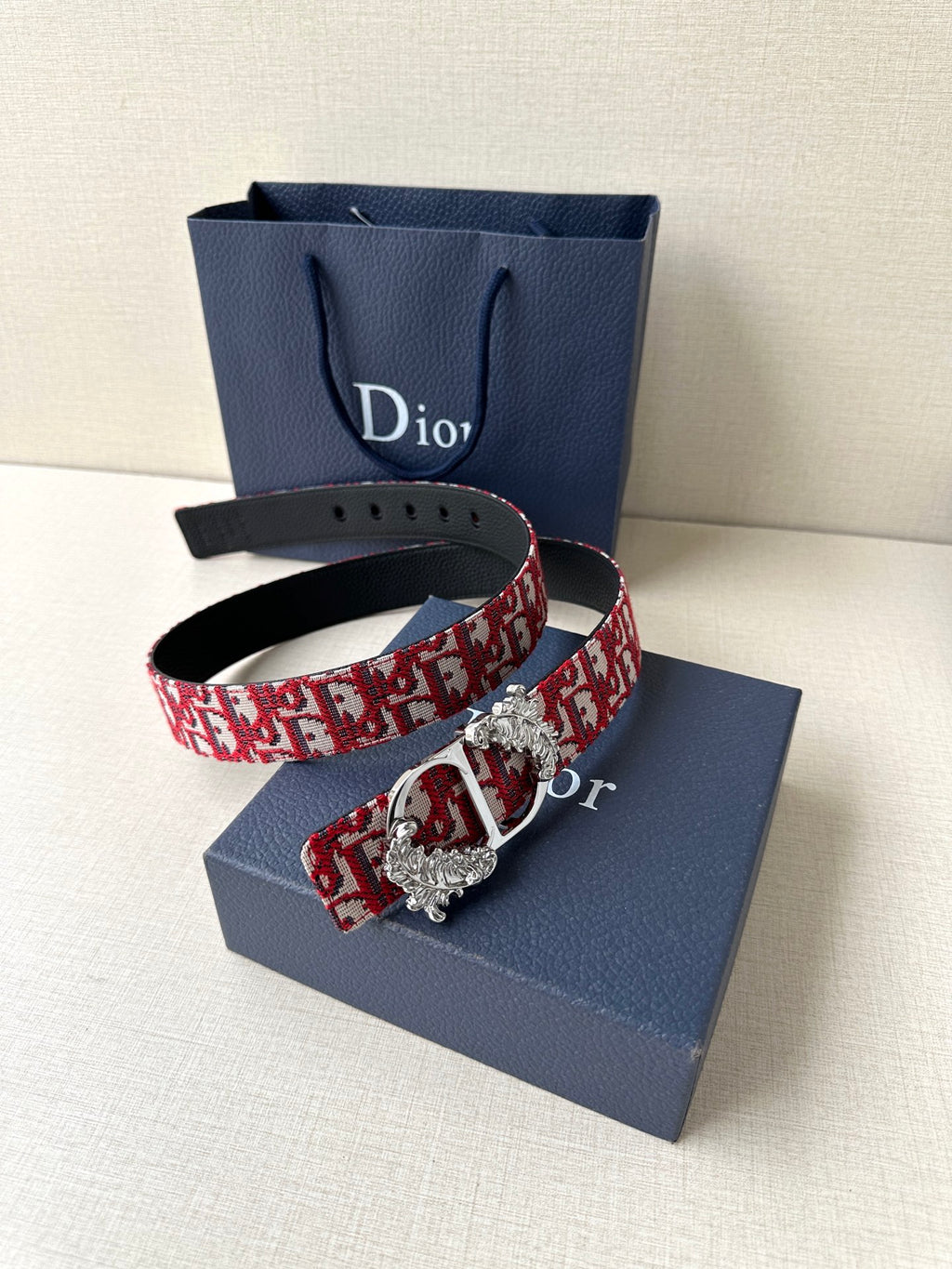 Dior belt with red monogram fabric and silver-tone buckle with engraved medallion