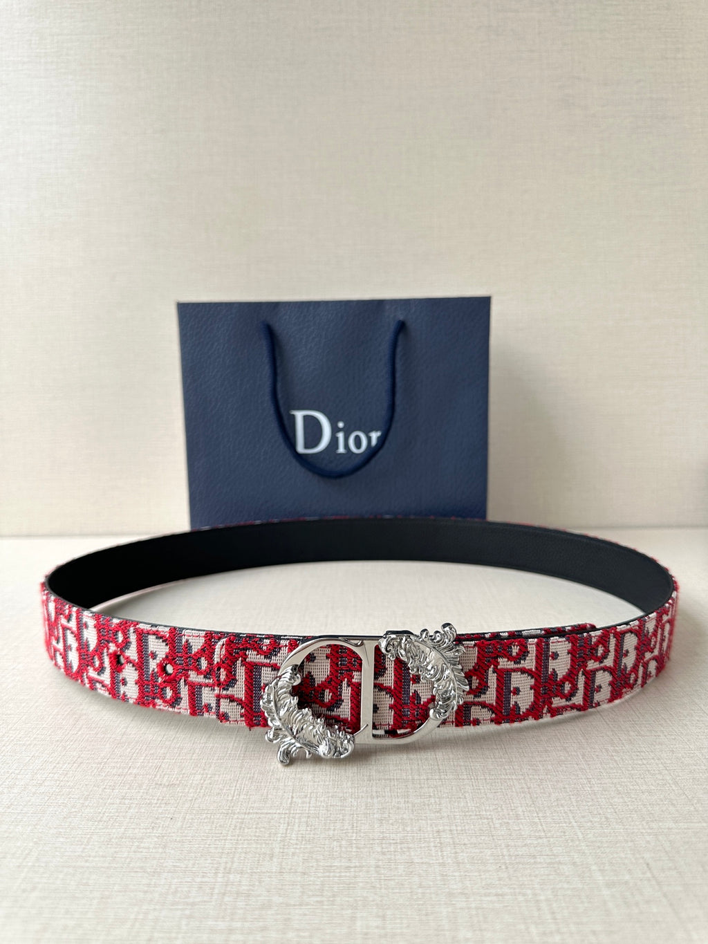 Dior belt with red monogram fabric strap and silver-tone buckle with floral detail