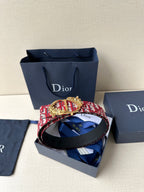 Red and white monogram belt with black strap and gold-tone crown buckle