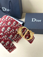 Red monogram belt detail with gold buckle frame and ornate crest centerpiece
