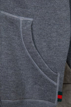 Heather gray hoodie sleeve with curved seam detail and multicolor trim at hem