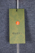 Green hang tag attached to the hoodie zipper, with Gucci branding