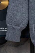 Heather gray hoodie sleeve cuff with ribbed hem and seam stitching detail